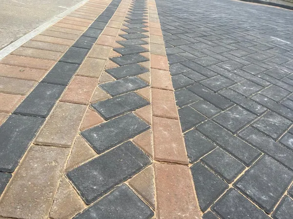 Close-up of a buff chevron running through a charcoal and buff double border