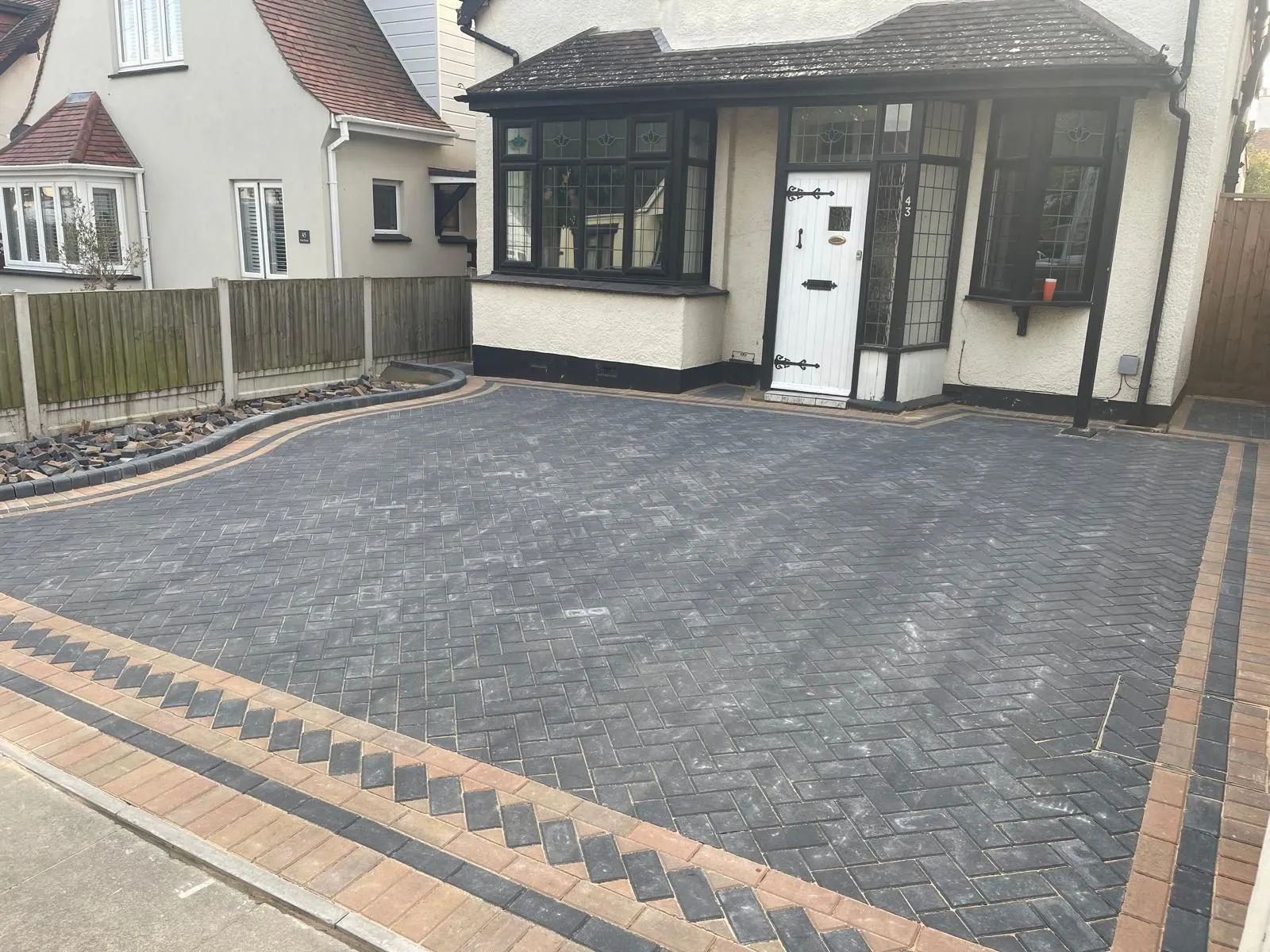 Driveways in Colchester: a new charcoal herringbone block paving driveway with a buff chevron border, laid by First4Driveways