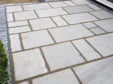 New large-format slab patio laid in a running pattern