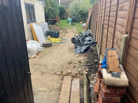 Side passage full of rubble and timber before the work