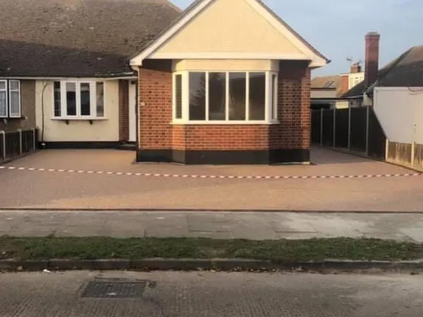 Golden resin bound driveway across the front of a bungalow